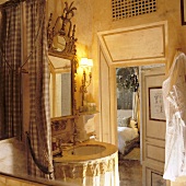 An antique en suite bathroom with a view of a bedroom