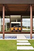 A terrace with a garden path and a view into a house