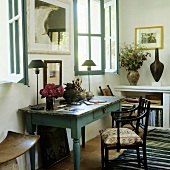 A wall table and a chair at the window in a simple country house