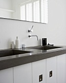 Designer bathroom sink area with wall faucet and mirror