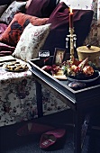 Side table with Christmas decoration next to a sofa with pillows