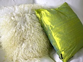 Two pillows with sheepskin cover and green silk