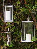 Lanterns with white candles hanging in a tree