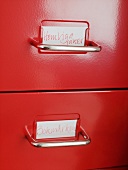 Red drawers will metal pulls and labels