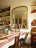Flowers and candlesticks on table in country style dining room