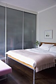 Doppelbett im Designer Schlafzimmer mit Einbauschrank und Glasschiebetüren