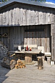 Exterior of rustic cabin with table and chairs outside