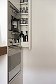 Integral oven in modern kitchen with pull-out storage