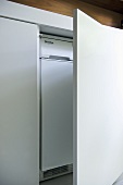 Integral appliance behind white fitted unit