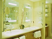 Twin washbasins set in unit with mirrors above