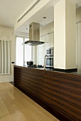 A kitchen counter with an integrated pillar in an open-plan kitchen
