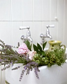 Flowers in a sink with vintage faucet