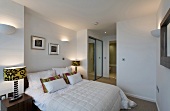 An open-plan bedroom with wall lighting
