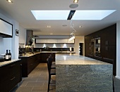 A stone dining table in an open-plan kitchen