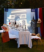 A festively laid table for a French-themed party in the open air