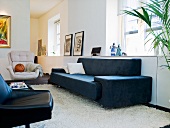 A living room with black and white seats