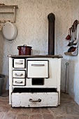A wood-fired oven in the corner of a kitchen