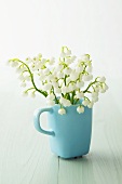 Lily of the valley in a turquoise cup