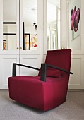 A red upholstered rocking chair