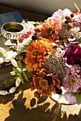 A summery bunch of flowers on a wooden table