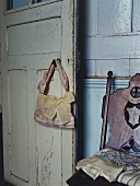 A handbag hanging on an old wooden door