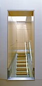 A view of modern stairway with built in wooden cupboards