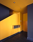 A minimalistic, arts and craft style stairway painted in strong yellow and black tones