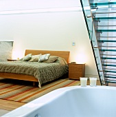 A bedroom with a bathtub and glass stairs