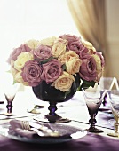 Arrangement of roses on laid table (close-up)