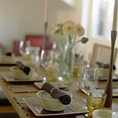 Laid table with fabric napkins, candles and flowers