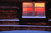 A cabin window in the snow