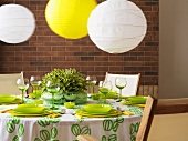 A green and white table with paper lampshades