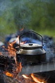 Tea kettle over a campfire