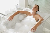 Young woman having a bubble bath