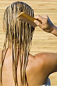 Rear view of a woman combing her hair