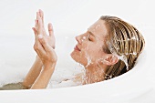 A woman splashing water on her face