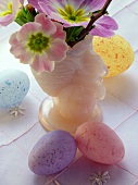 Pastel-coloured Easter eggs and pink flowers