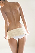 Young woman with back scrubber