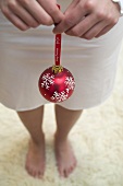 Young woman holding a Christmas bauble