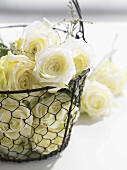 White roses in wire basket