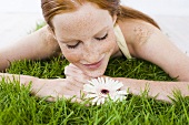 Young woman relaxing on grass