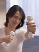 Woman training with hand weights