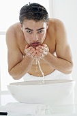 Man washing his face