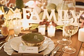 Christmas place-setting with place card, wine glasses