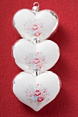 Three silver hearts with rose motifs (Xmas tree ornaments)