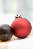 Two Christmas baubles on Christmas parcel