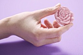 Hand holding rose soap