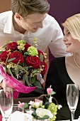 Man giving woman a bouquet of flowers