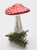 Christmas decoration (fly agaric) on sprig of fir