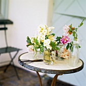 Several vases of flowers on garden table
